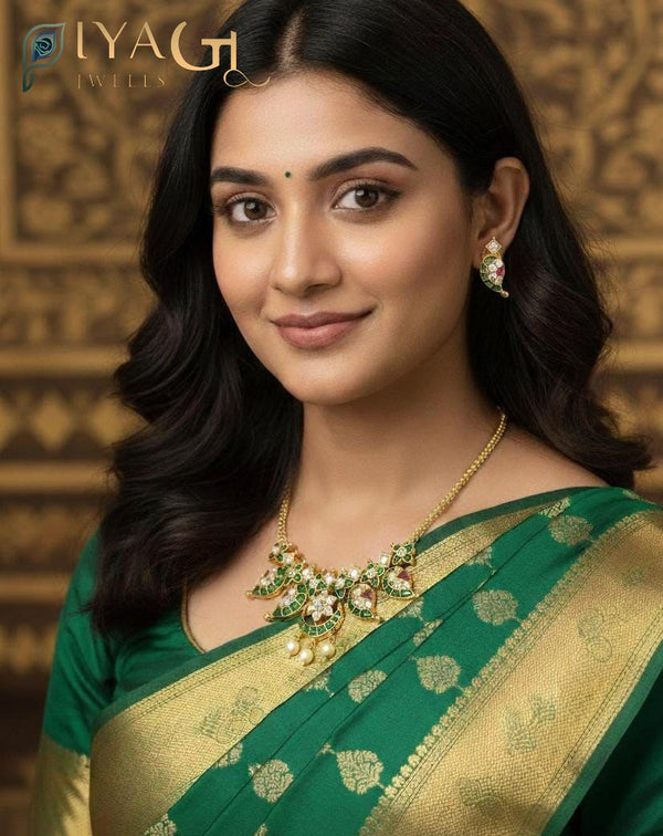 Close up of a gold-tone necklace set with green and white stones on a bust stand. - PiyaGuJwells