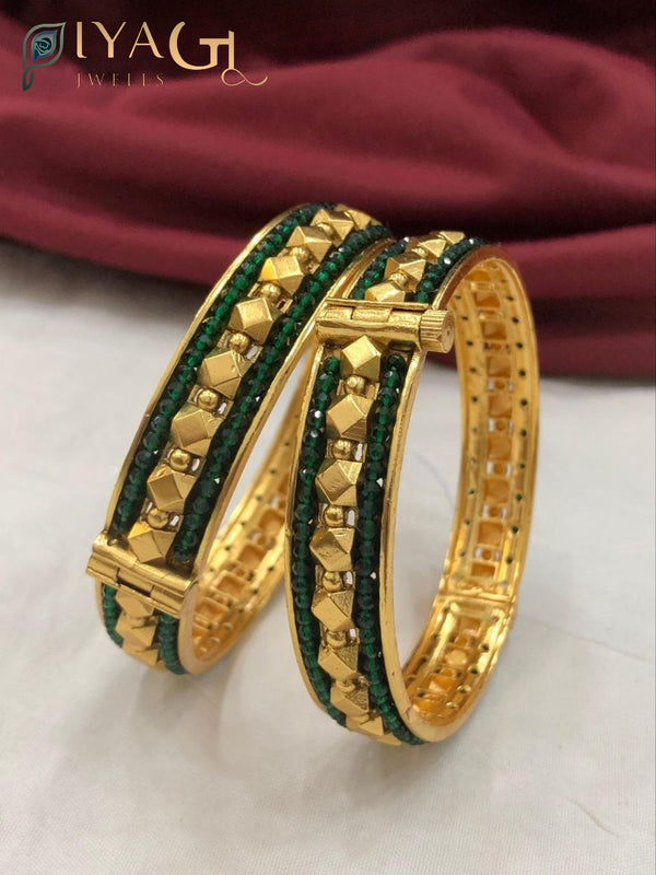 Gold tone bangle set with green and red stones and pyramid designs - PiyaGuJwells