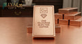 1 kilogram 99.9 percent fine copper bar Cu bullion ingot on wooden surface