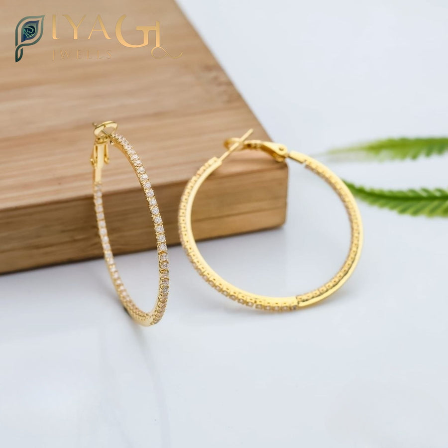 Large gold-toned hoop earrings with pave stones resting on a wooden surface, labeled as big size hoops measuring 4 cm. - PiyaGuJwells
