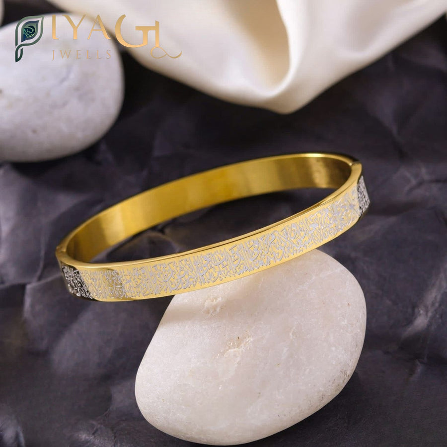 Gold and silver engraved stainless steel bracelet on a white stone. - PiyaGuJwells