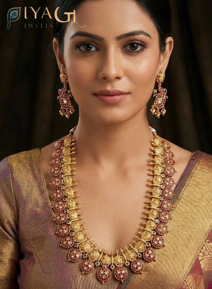 Close up of an antique polish brass metal long haram set with kempu stones, matching earrings and maang tikka displayed on a mannequin. - PiyaGuJwells