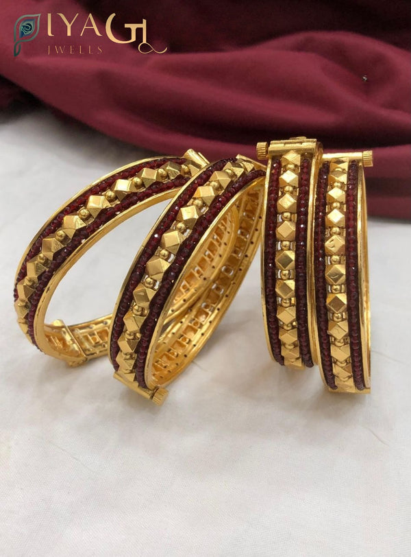 Antique finish brass bangle set with red and green stone variations featuring screw type mechanism and pyramid stud detailing - PiyaGuJwells