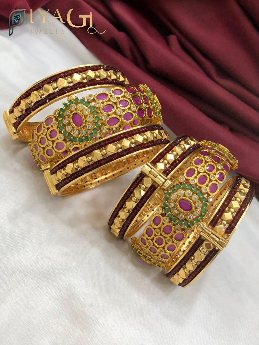 Gold tone imitation bangle kadda set with pink, green, and maroon AD stones on a white background. - PiyaGuJwells
