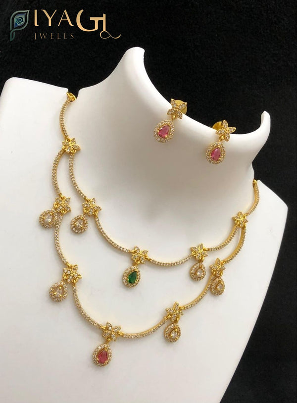 Antique finish layered necklace set with floral motifs and colored stone pendants displayed on a mannequin and model wearing the jewelry. - PiyaGuJwells