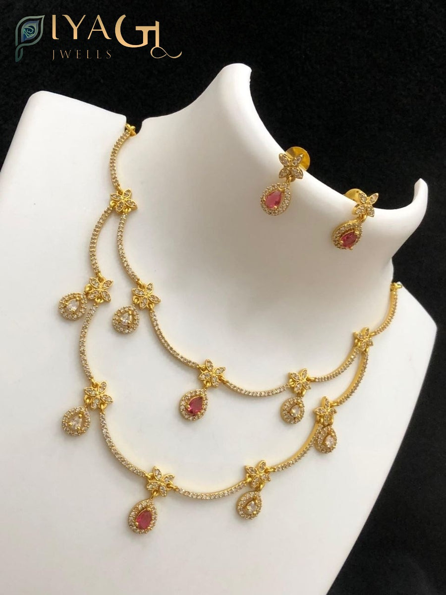 Antique finish layered necklace set with floral motifs and colored stone pendants displayed on a mannequin and model wearing the jewelry. - PiyaGuJwells
