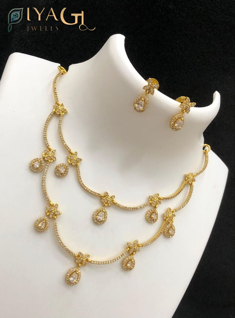 Antique finish layered necklace set with floral motifs and colored stone pendants displayed on a mannequin and model wearing the jewelry. - PiyaGuJwells