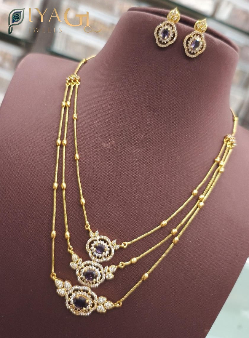 Gold finished blue cubic zirconia floral design layered necklace earring set for festive occasions - PiyaGuJwells