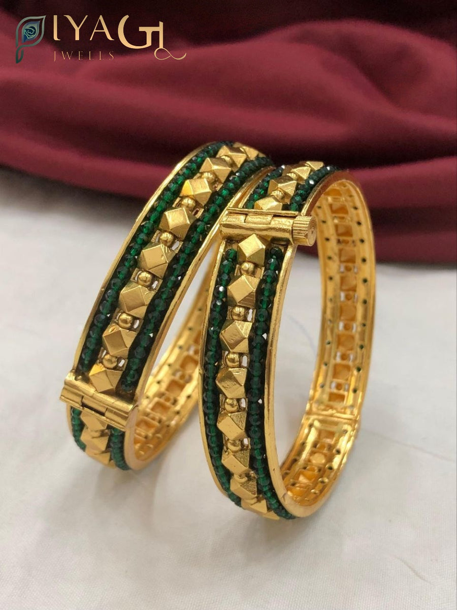 Gold tone bangle set with green and red stones and pyramid designs - PiyaGuJwells