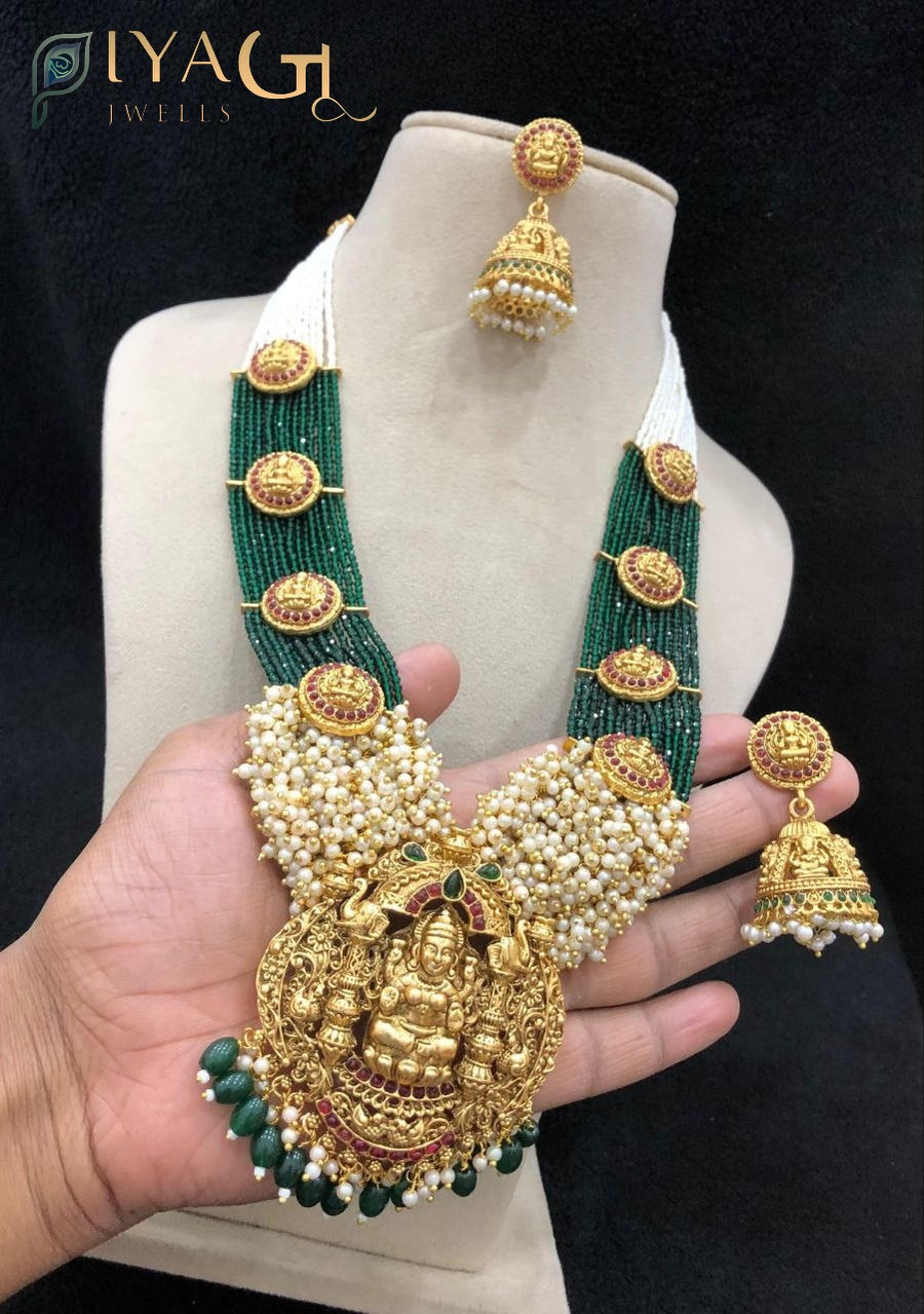 Green kempu stones and white pearls on antiqued gold tone layered necklace set for festive wear - PiyaGuJwells