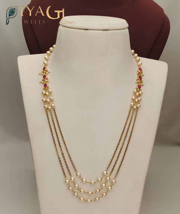A white mannequin displaying a PC's imitation necklace with pearls and red stones in a multi-layer design. - PiyaGuJwells