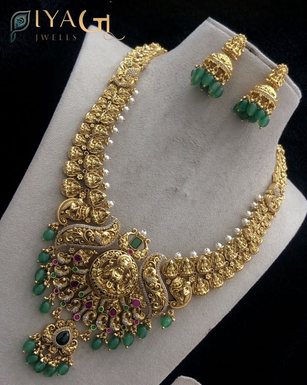 Gold polished layered necklace with green jadau stones featuring a floral motif for festive occasions - PiyaGuJwells