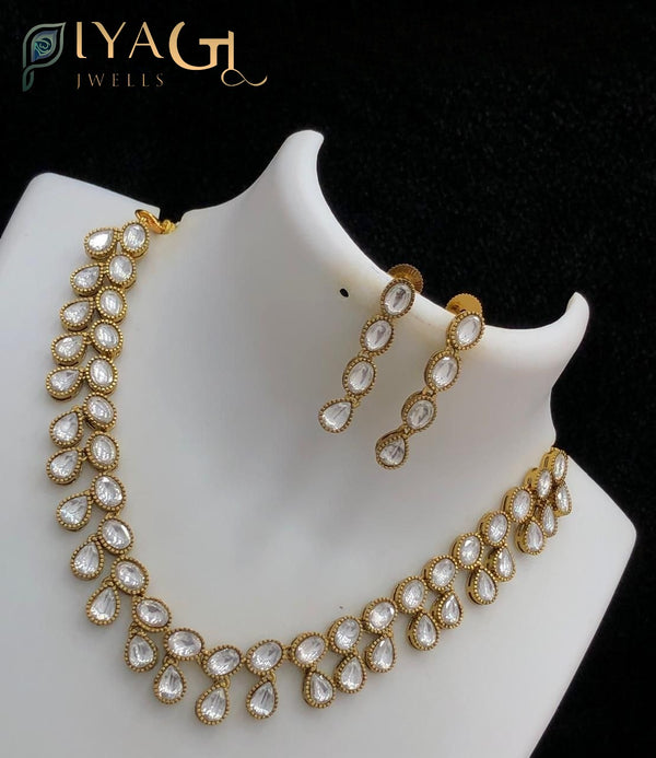Gold tone white stone teardrop floral design choker necklace for festive occasions - PiyaGuJwells
