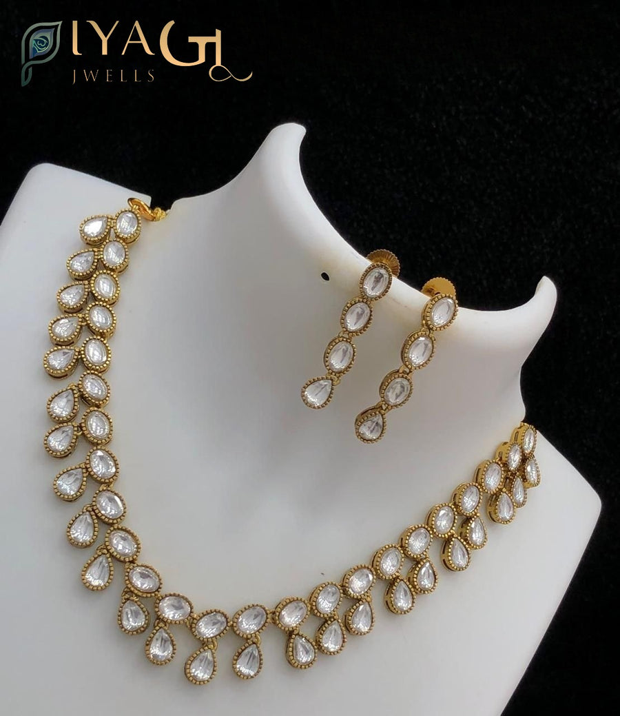 Gold tone white stone teardrop floral design choker necklace for festive occasions - PiyaGuJwells