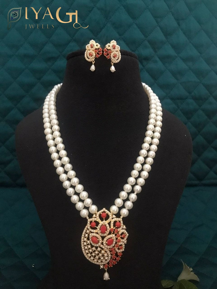 Imitation pearl mala set with matching earrings and pendant in purple, red, and white variations displayed on a black bust. - PiyaGuJwells