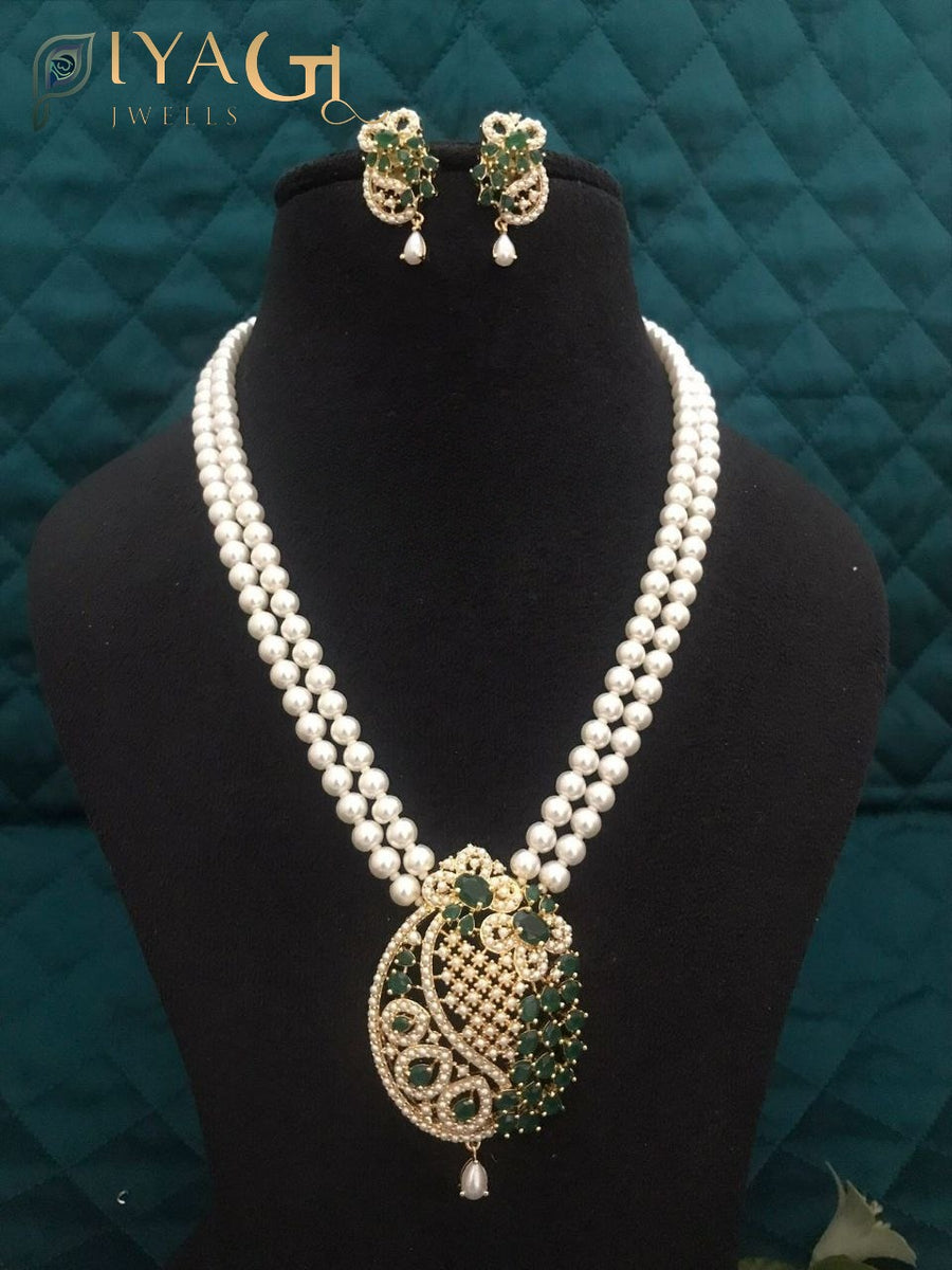 Imitation pearl necklace set with heavy pendant and matching earrings displayed on a bust. - PiyaGuJwells