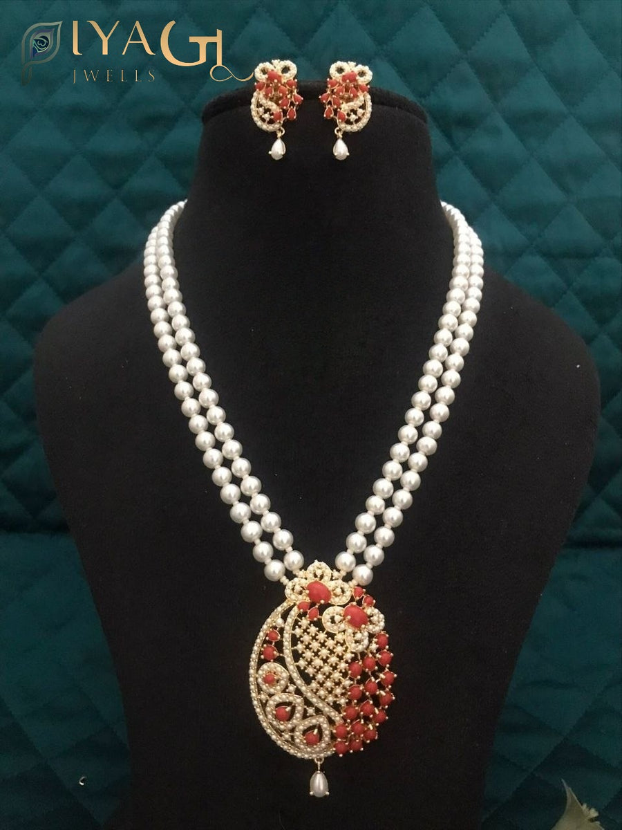 Imitation pearl necklace set with heavy pendant and matching earrings displayed on a bust. - PiyaGuJwells