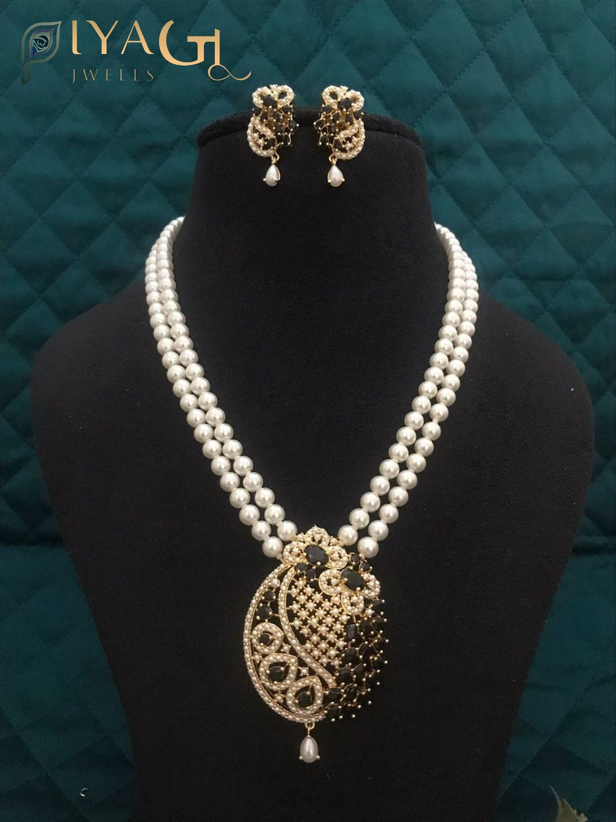 Imitation pearl necklace set with heavy pendant and matching earrings displayed on a bust. - PiyaGuJwells