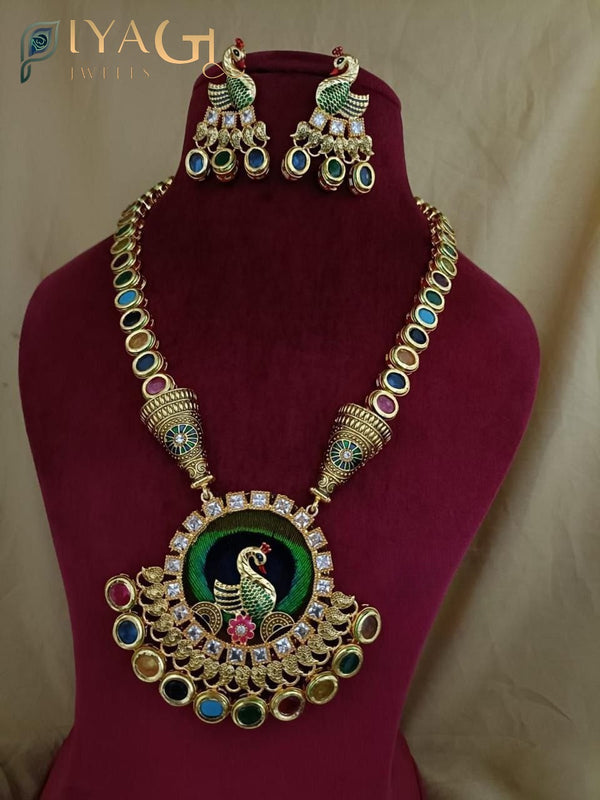 Golden tone with vibrant multicolored stones in a layered peacock design for festive wear - PiyaGuJwells