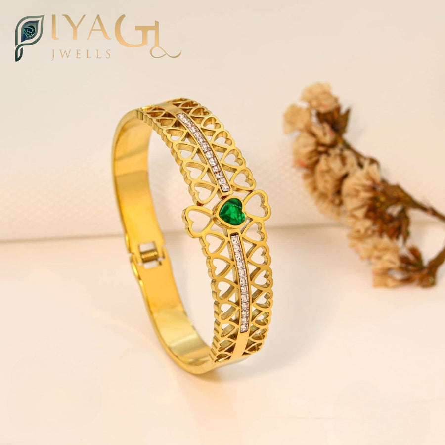 Gold finish imitation bangle with heart cutouts and green center stone - PiyaGuJwells